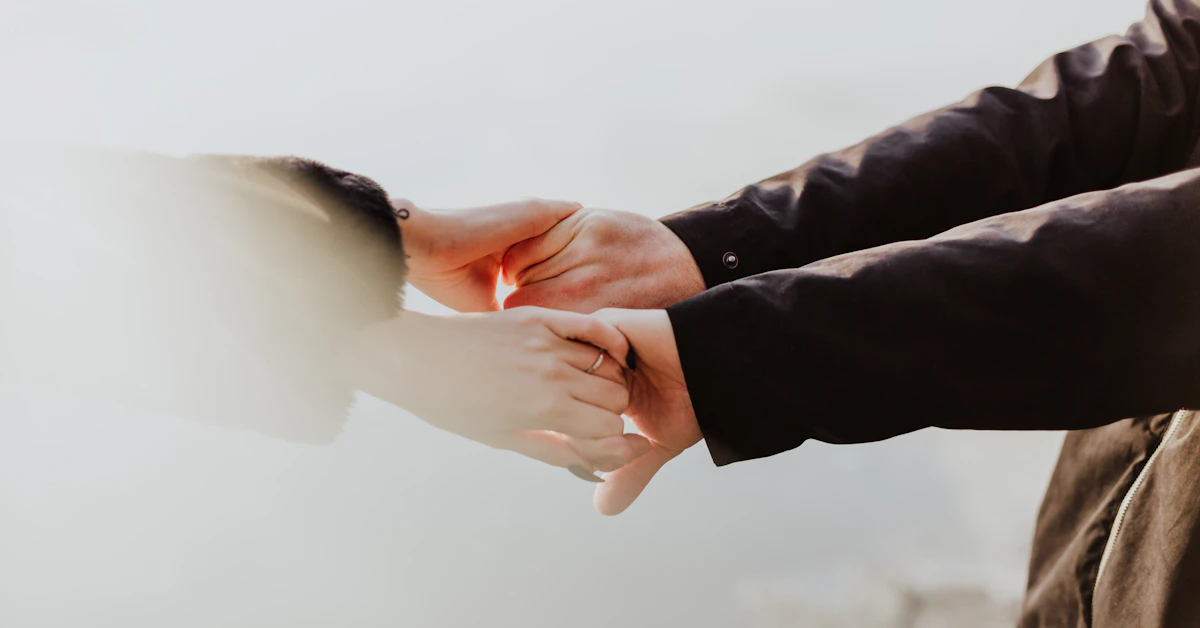 a couple holding hands while standing next to each other