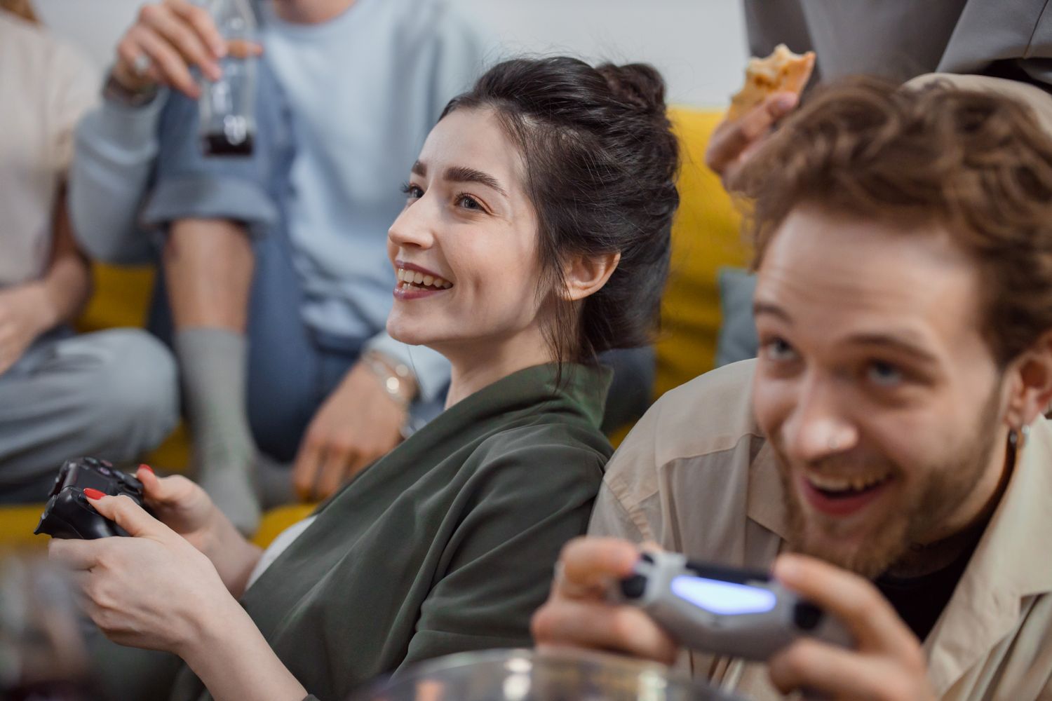 Group of friends enjoying video games and snacks, capturing fun and happiness.
