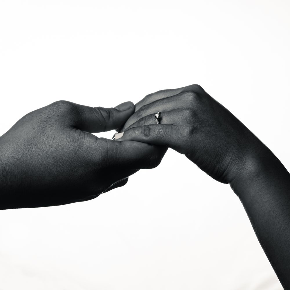 Black and white image of couple's hands with engagement ring in Philippines.