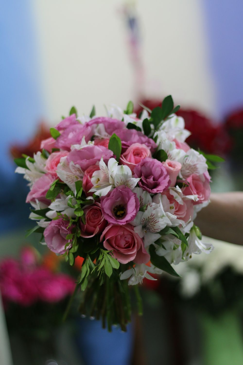 Beautiful bouquet of pink and white flowers held in a hand, perfect for weddings.
