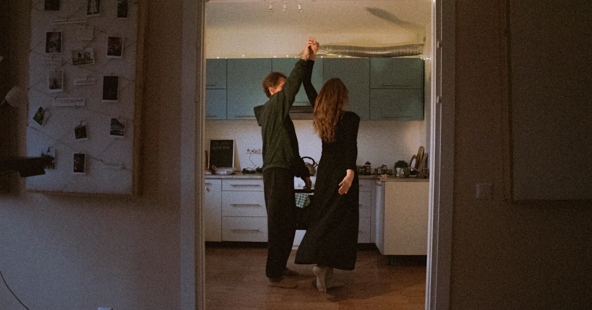 Couple dancing in a kitchen at night