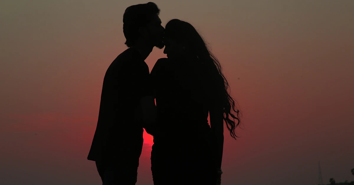 silhouette of couple kissing during sunset